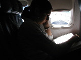 monica reading on plane